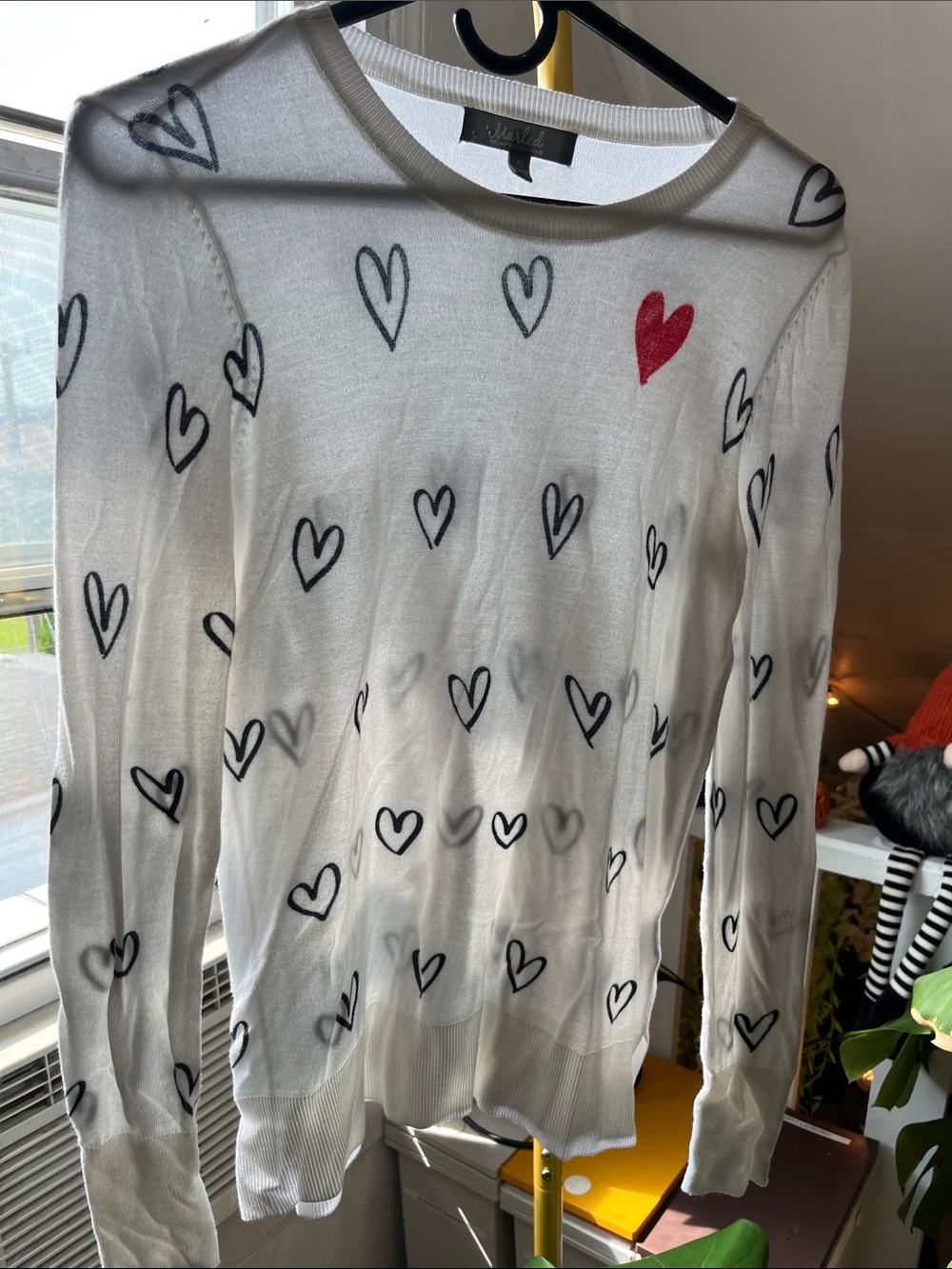 Marled White Crewneck Sweater with Black Heart Motif and Red Accent
